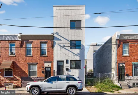 a front view of a building with parking space