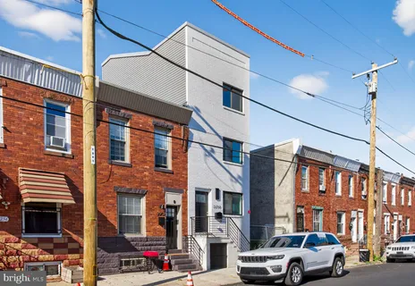 a couple of cars parked in front of brick building