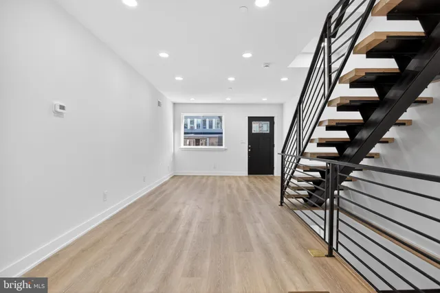 wooden floor in an empty room with stairs