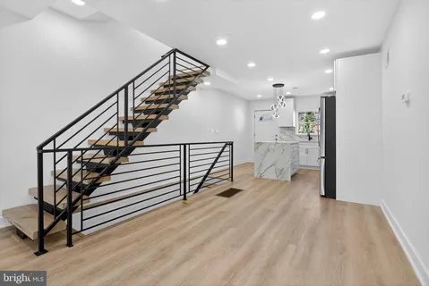 a view of entryway and hall with wooden floor