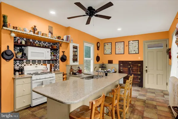 a kitchen with stainless steel appliances kitchen island granite countertop a sink and cabinets