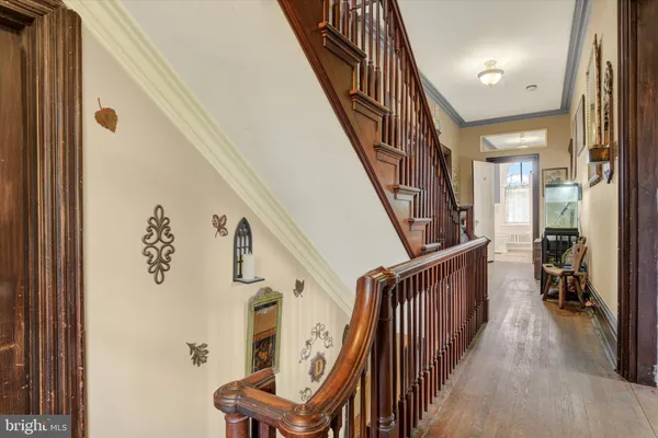 a view of entryway with wooden floor and stairs