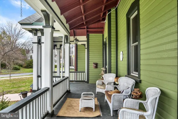 a balcony with chairs and a table