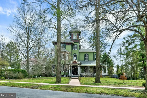 a front view of a house with a yard table and chairs