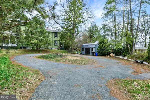 a view of a house with a yard and tree s
