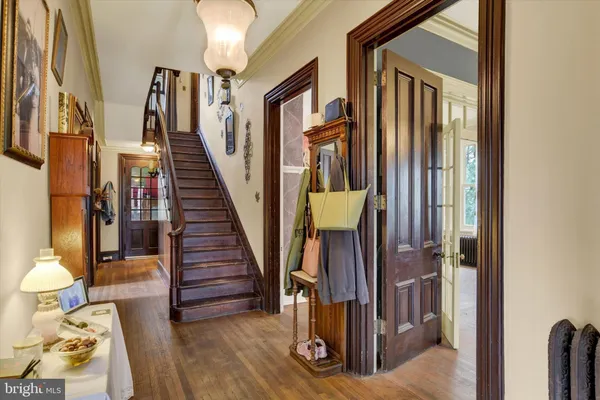 a view of entryway and hall with wooden floor