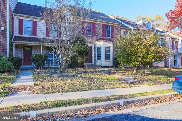 a view of a brick building next to a yard