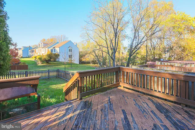 a view of a wooden deck with a yard