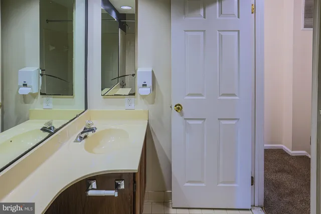 a bathroom with a sink toilet and mirror