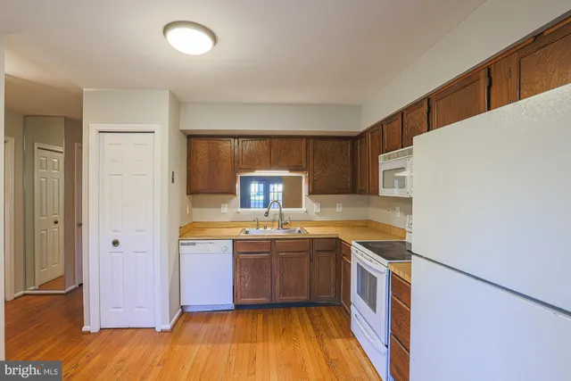 a kitchen with a sink a stove a refrigerator and a oven
