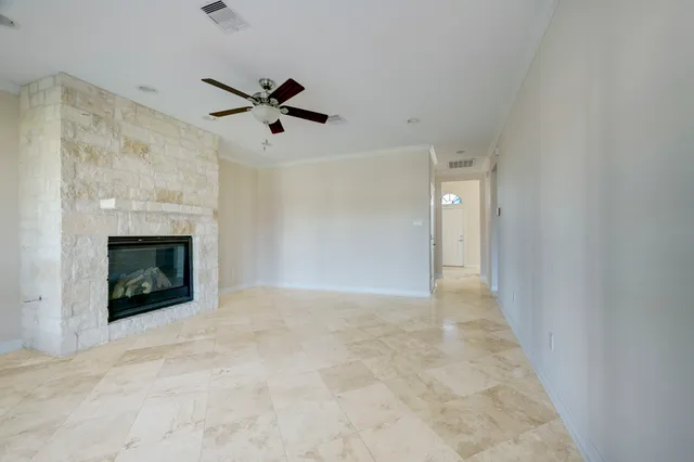 a view of an empty room with a fireplace
