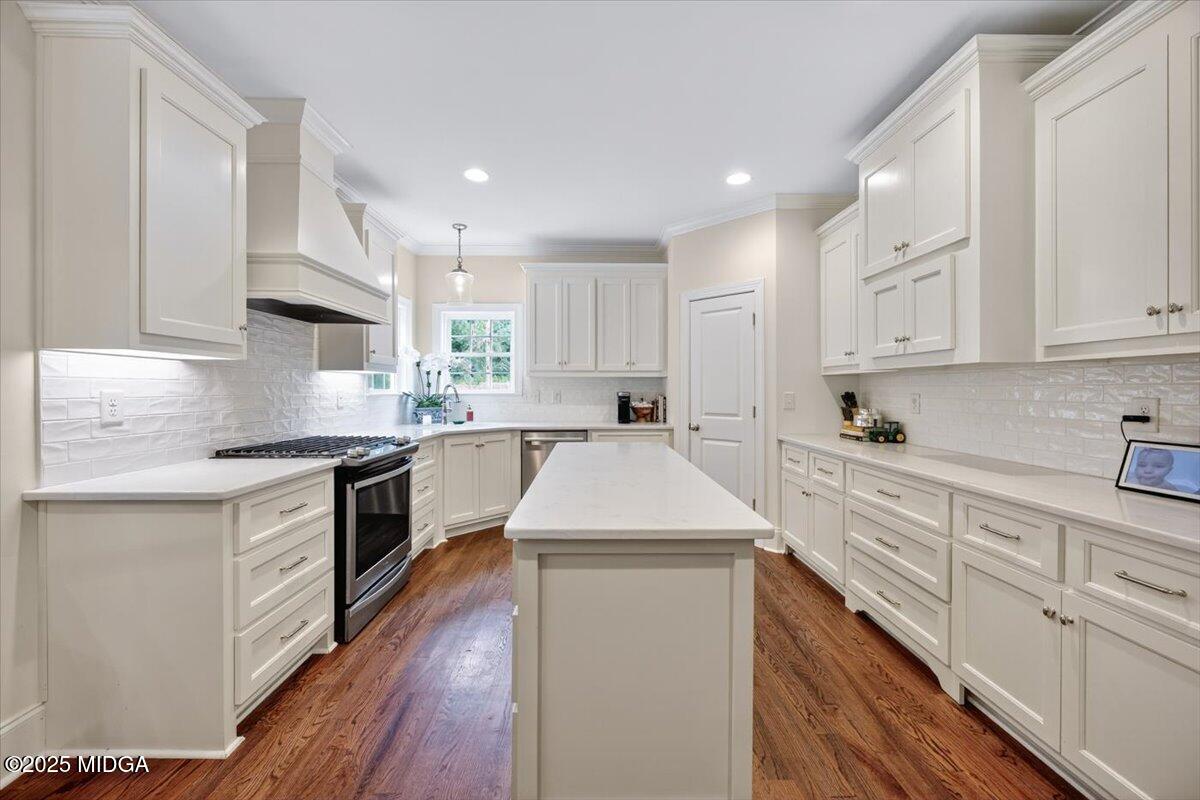 178 Broadleaf Drive Macon, GA 31210 - Photo 12 of 45 a kitchen with kitchen island granite countertop a sink a stove top oven and white cabinets