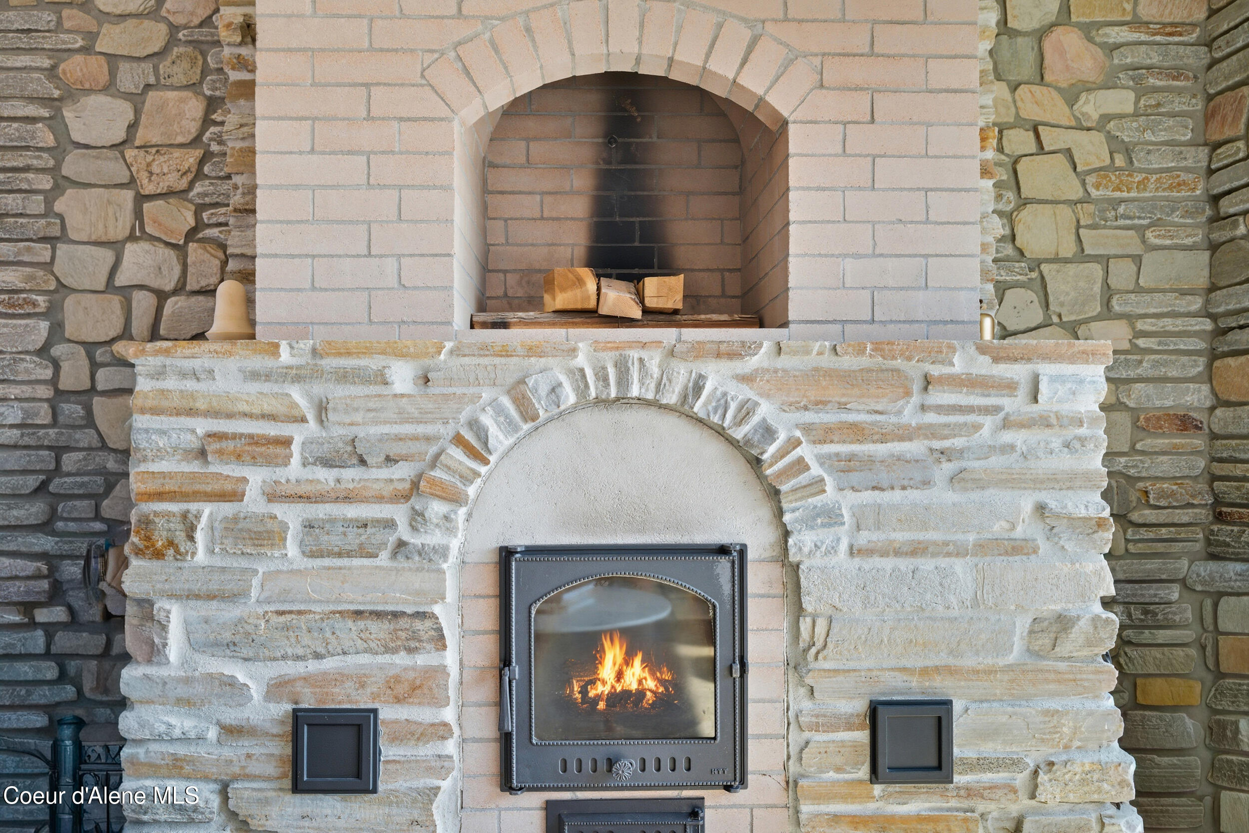 76 Caseys Lane Sandpoint, ID 83864 - Photo 11 of 67 dual use fireplace and woodstove