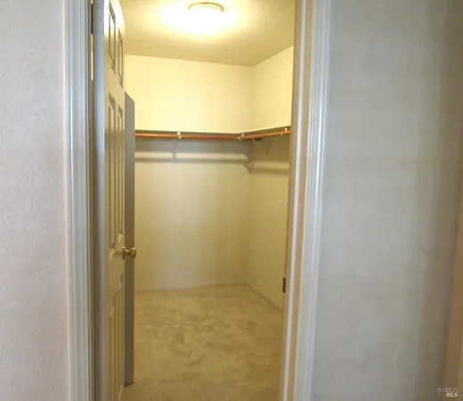 a view of a room with a window and wooden floor