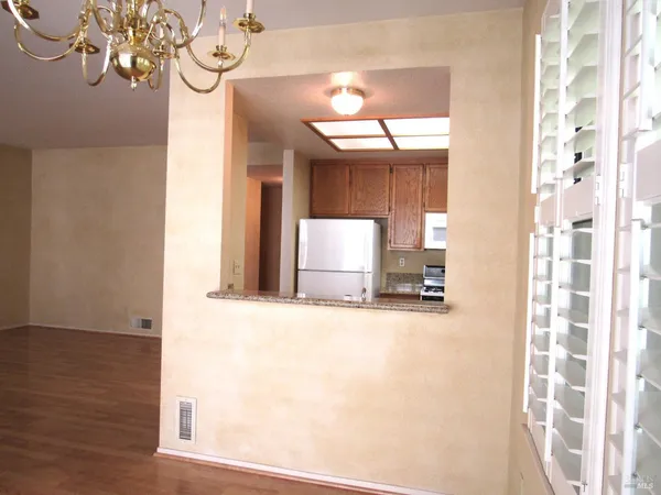a view of a patio with chairs and plants