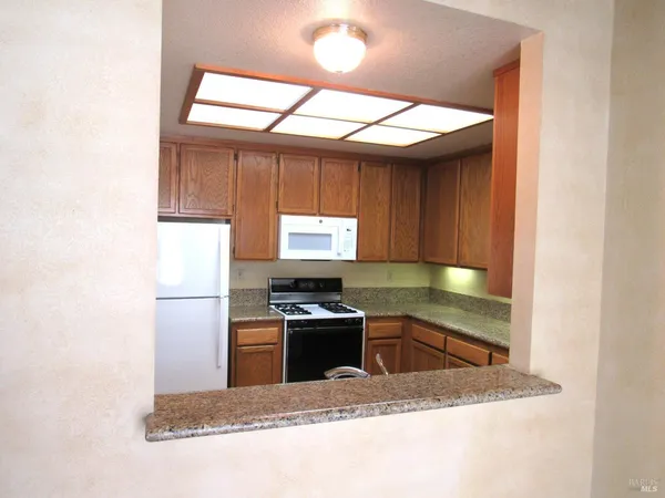 a kitchen with a stove a sink and a refrigerator