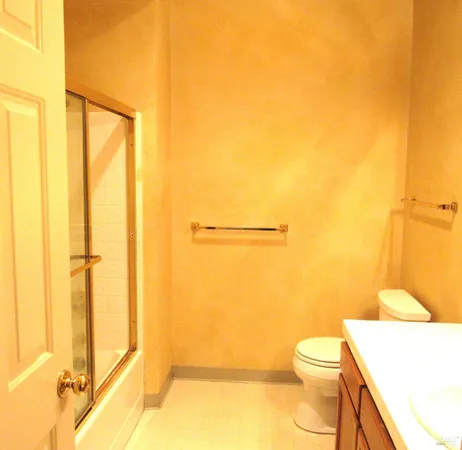 a bathroom with a toilet and a shower
