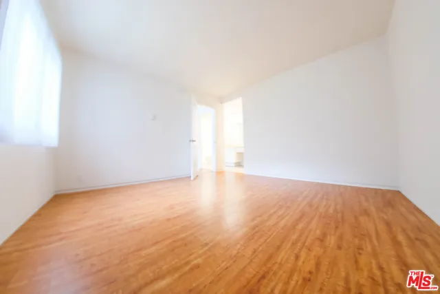 a view of an empty room and wooden floor