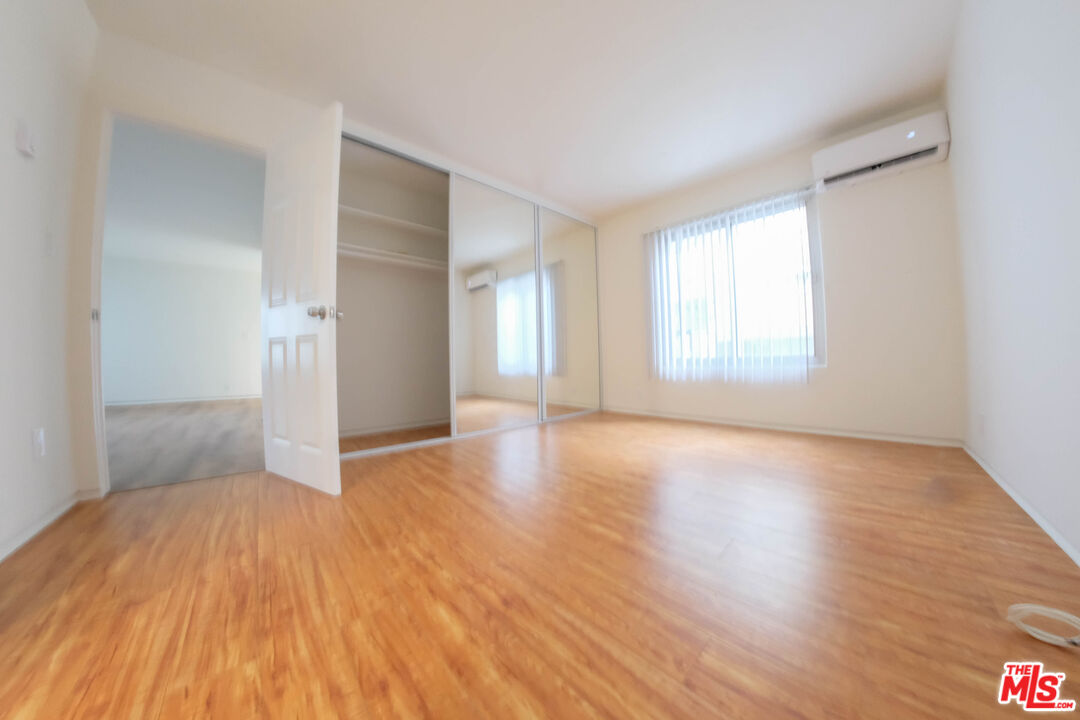 7758 West 91st Street, Unit 2 Playa del Rey, CA 90293 - Photo 16 of 24 an empty room with wooden floor and windows