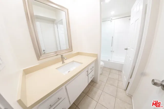 a bathroom with a sink a mirror and a bathtub