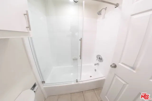 a bathroom with a tub and a shower