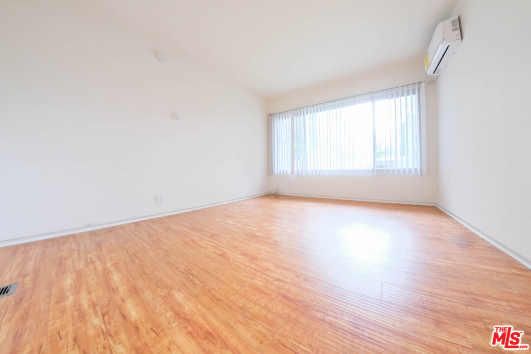 7758 West 91st Street, Unit 2 Playa del Rey, CA 90293 - Photo 21 of 24 an empty room with wooden floor and windows