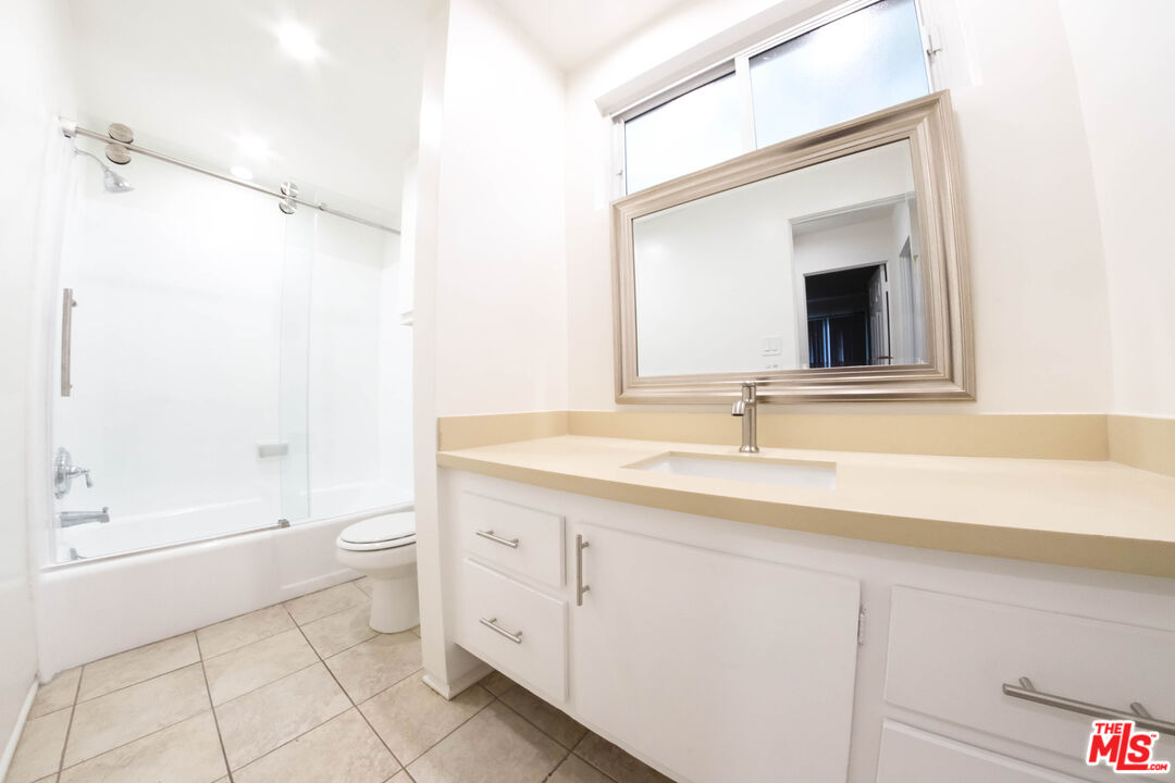 7758 West 91st Street, Unit 2 Playa del Rey, CA 90293 - Photo 23 of 24 a bathroom with a granite countertop sink a toilet and a bathtub