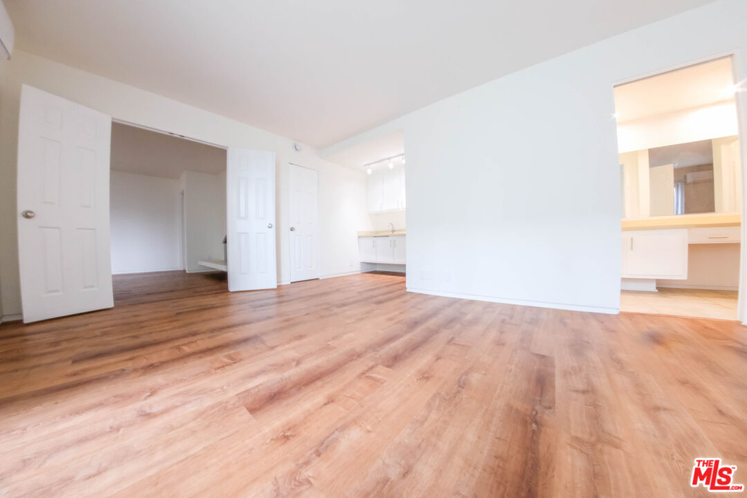 7758 West 91st Street, Unit 2 Playa del Rey, CA 90293 - Photo 7 of 24 a view of empty room with wooden floor and fan