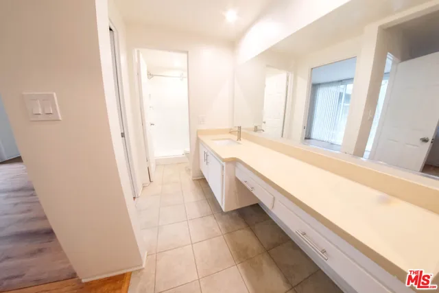 a bathroom with a sink a mirror and a bathtub