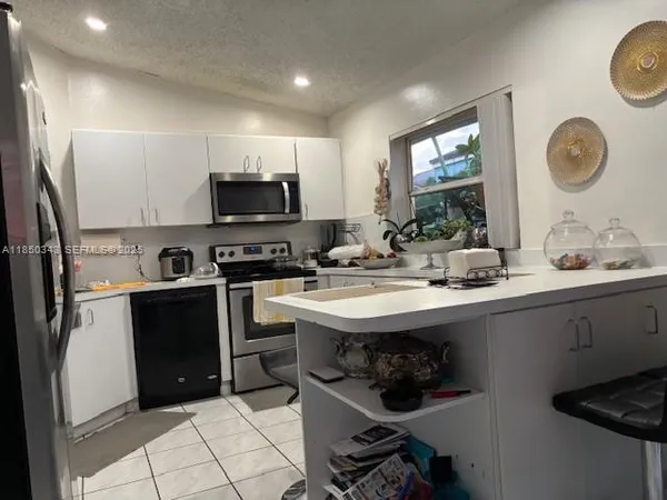 a kitchen with a sink cabinets and appliances