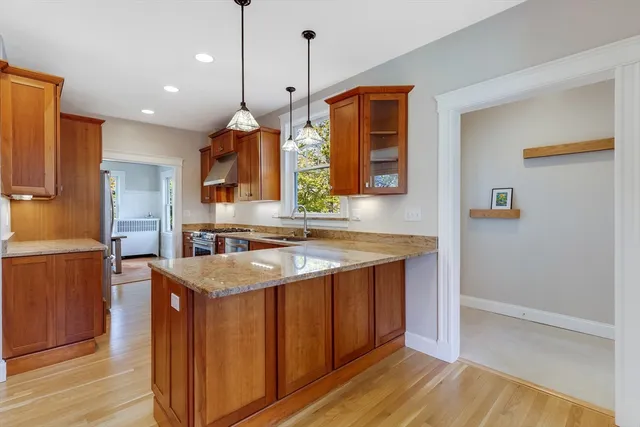 a kitchen with a sink a counter top space and cabinets