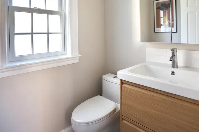 a white toilet sitting next to a bathroom sink