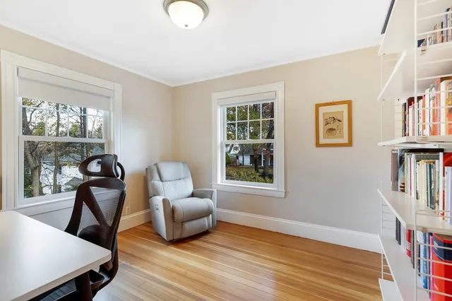 a view of a livingroom with furniture wooden floor and a book shelf