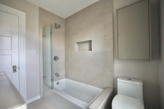 a bathroom with a toilet and a bathtub