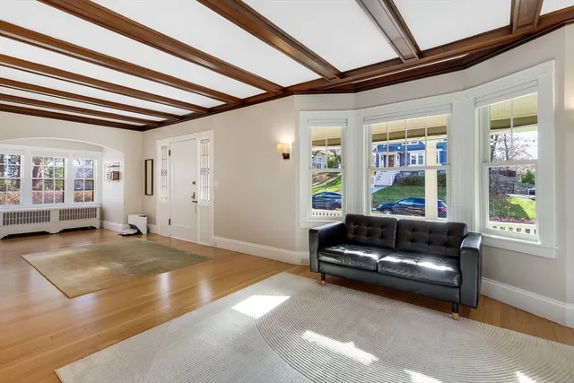 a living room with furniture and large windows