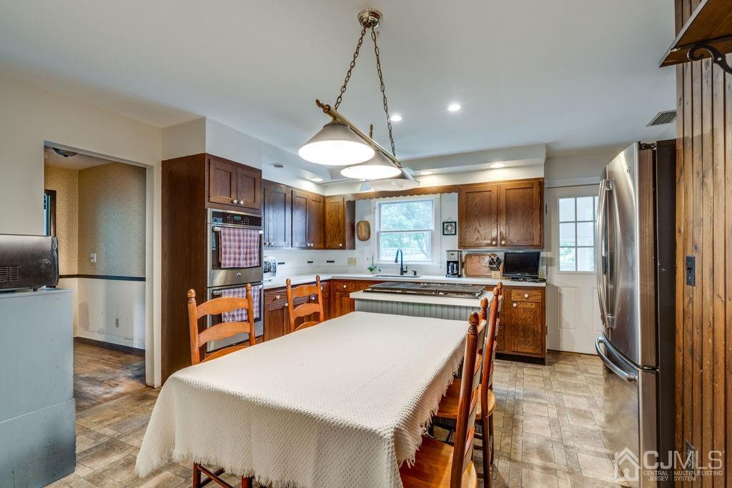 670 Ridge Road Monmouth Junction, NJ 08852 - Photo 12 of 26 a kitchen with stainless steel appliances a sink counter space refrigerator and cabinets