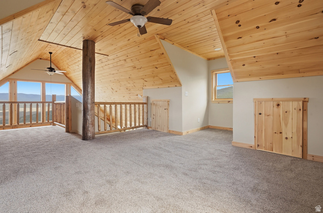20 Q Puma Road Fairview, UT 84629 - Photo 16 of 27 Spacious loft area featuring a natural wood plank ceiling, light gray carpet flooring, and a log support beam