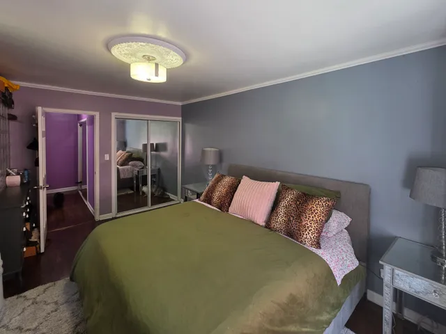 a bed sitting in a bedroom next to a lamp