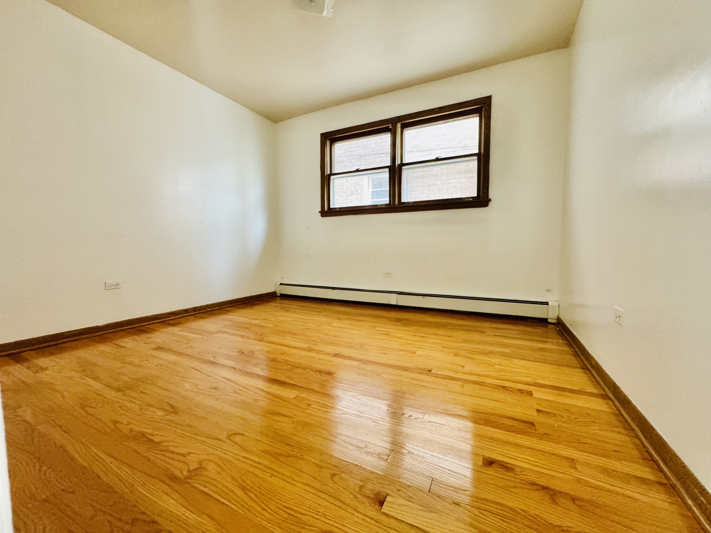 4211 West 63rd Street, Unit 1 Chicago, IL 60629 - Photo 12 of 13 a view of a room with wooden floor and a window