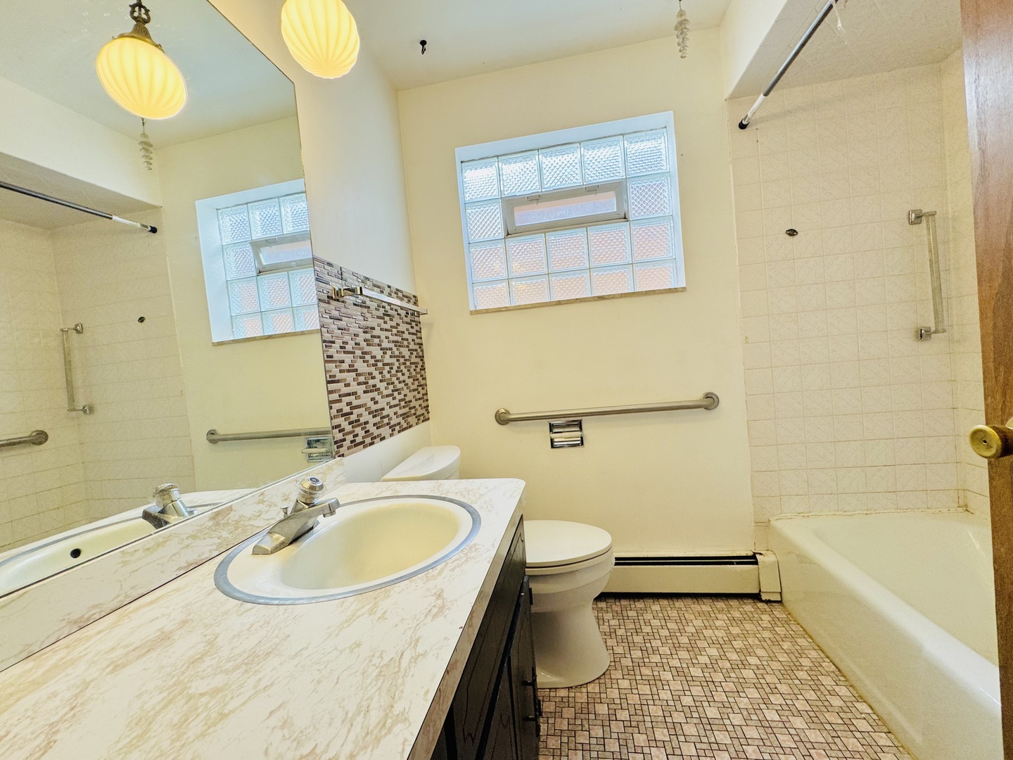4211 West 63rd Street, Unit 1 Chicago, IL 60629 - Photo 9 of 13 a bathroom with a sink toilet and shower