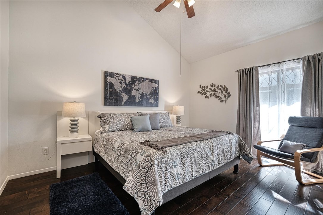 1748 Ohlen Road, Unit 74 Austin, TX 78757 - Photo 10 of 15 a bedroom with a bed and wooden floor