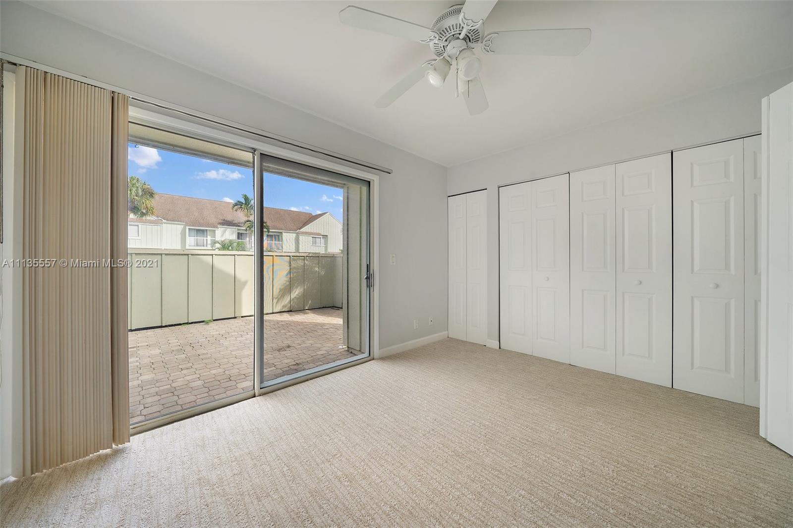6351 Riverwalk Lane, Unit 4 Jupiter, FL 33458 - Photo 12 of 46 a view of an empty room with glass door