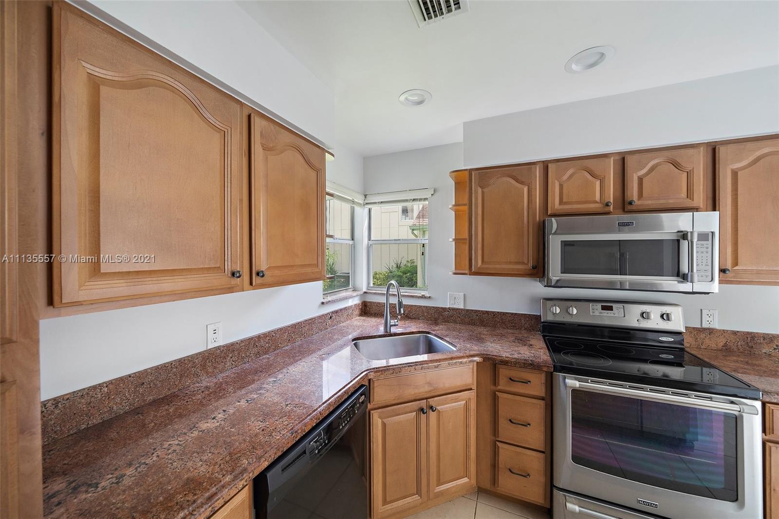 6351 Riverwalk Lane, Unit 4 Jupiter, FL 33458 - Photo 17 of 46 a kitchen with granite countertop cabinets stainless steel appliances and a sink