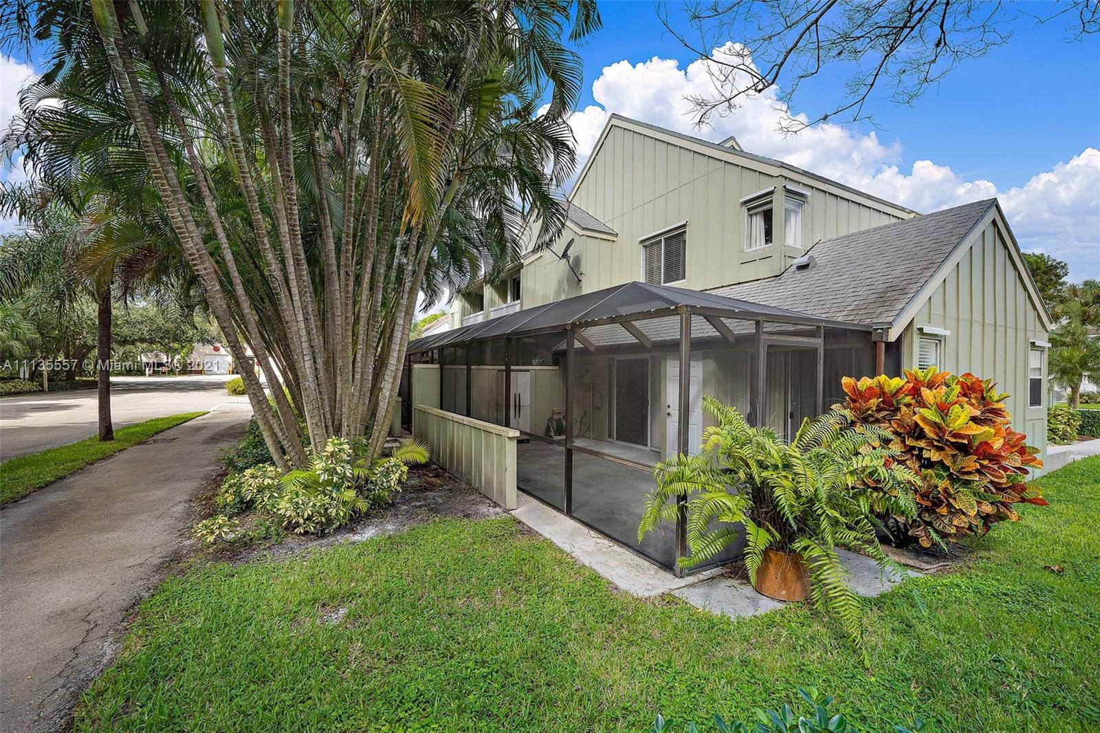 6351 Riverwalk Lane, Unit 4 Jupiter, FL 33458 - Photo 23 of 46 a front view of a house with a garden