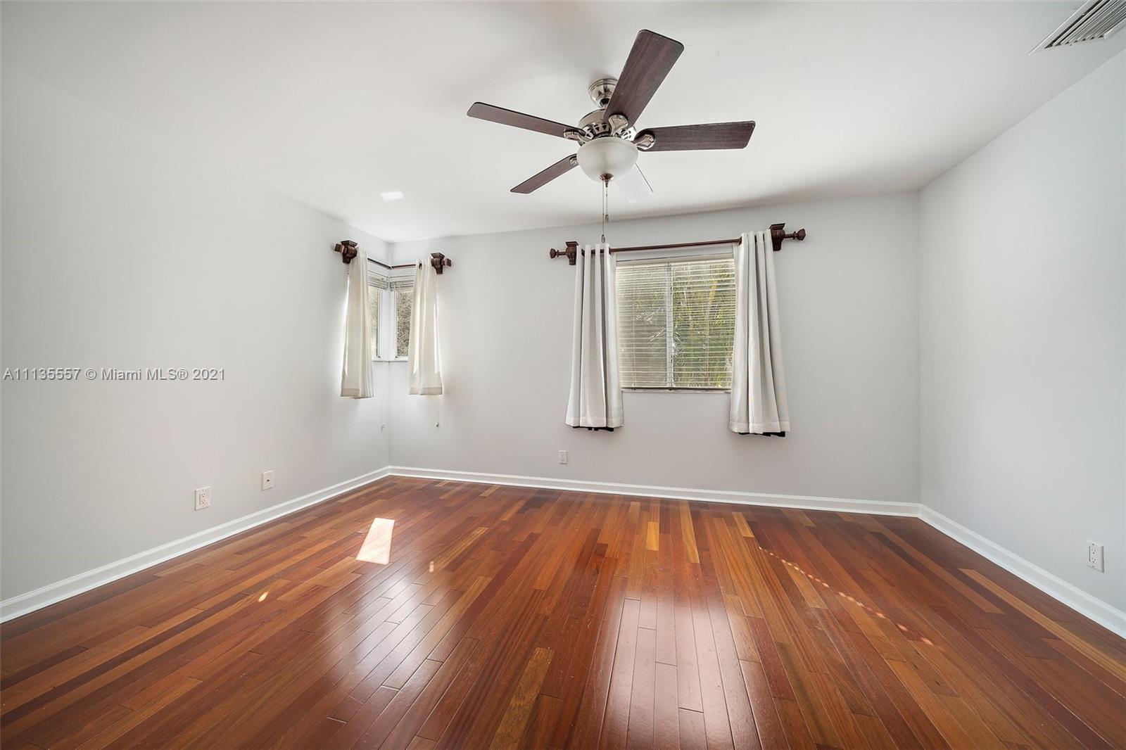 6351 Riverwalk Lane, Unit 4 Jupiter, FL 33458 - Photo 25 of 46 wooden floor in an empty room with a window