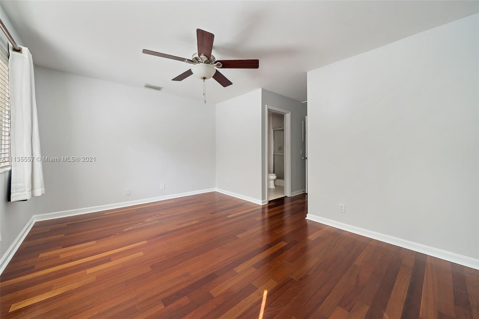 6351 Riverwalk Lane, Unit 4 Jupiter, FL 33458 - Photo 27 of 46 a view of room with hardwood floor and a ceiling fan