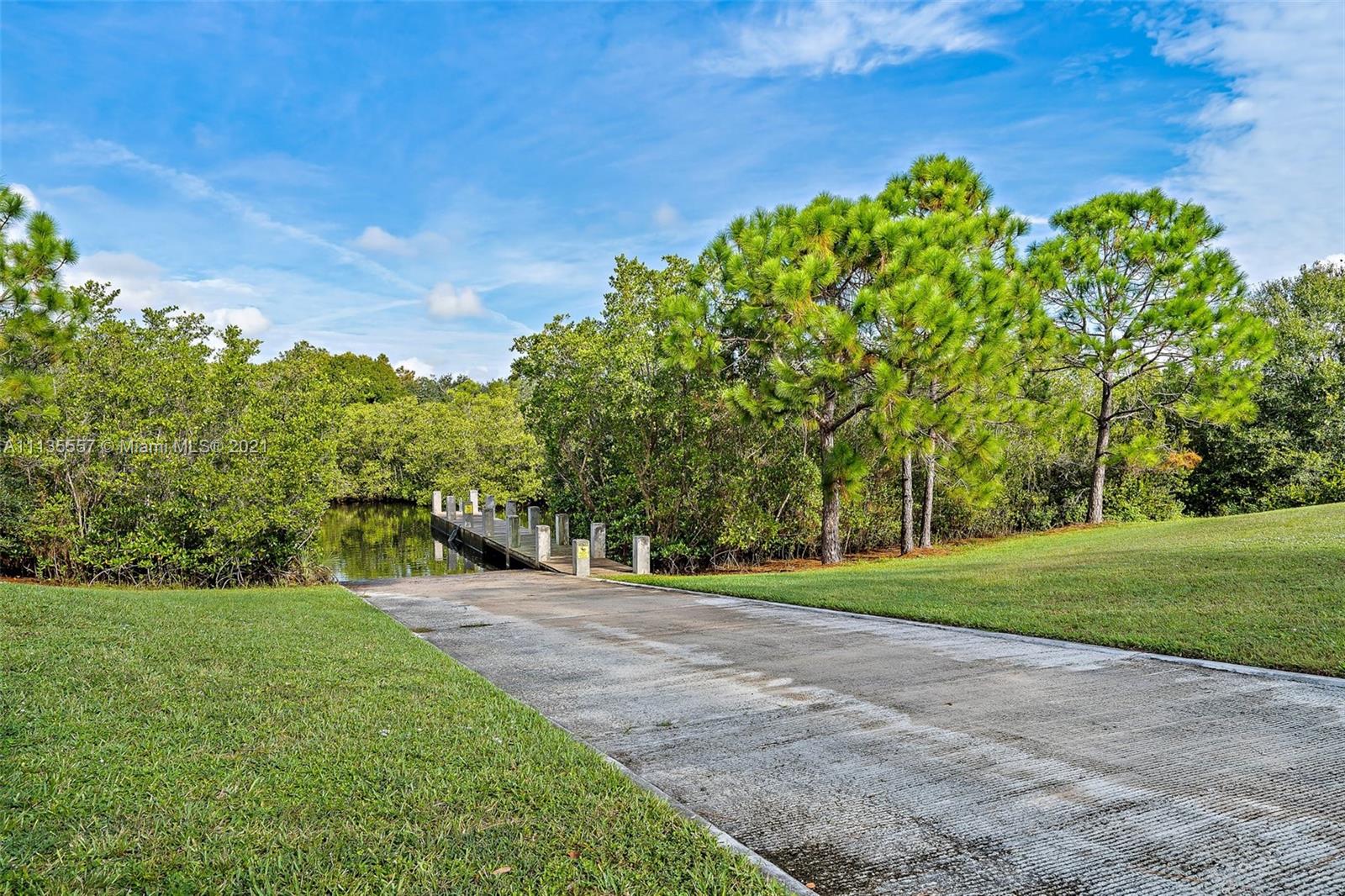 6351 Riverwalk Lane, Unit 4 Jupiter, FL 33458 - Photo 35 of 46 a view of a grassy field with trees