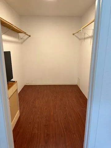 a view of a room with wooden floor and cabinet