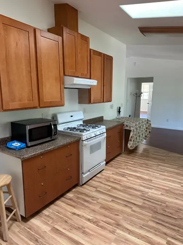 a kitchen with a stove a sink and a microwave