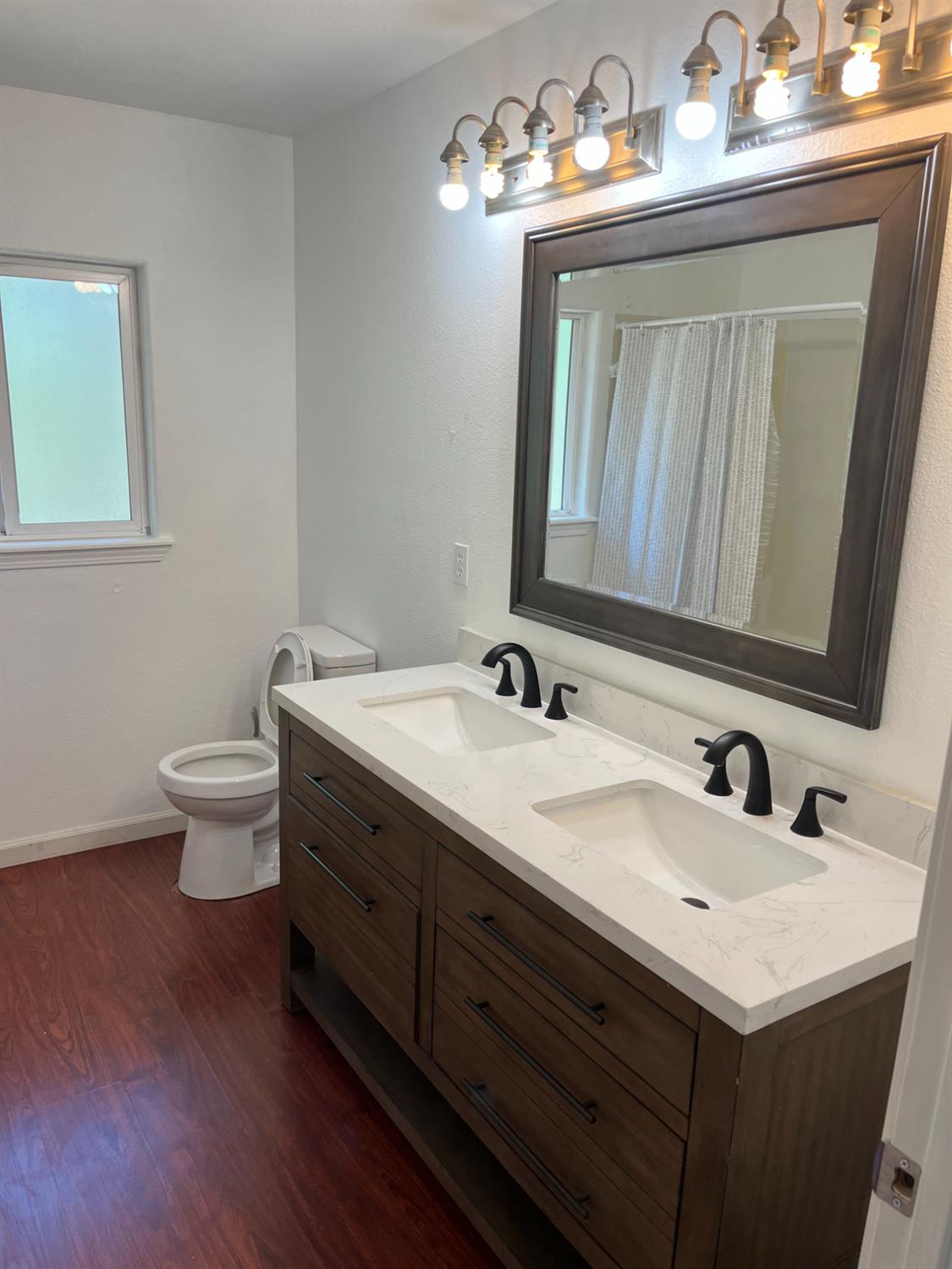16164 Nugget Road Corning, CA 96021 - Photo 8 of 17 a bathroom with a toilet sink and mirror